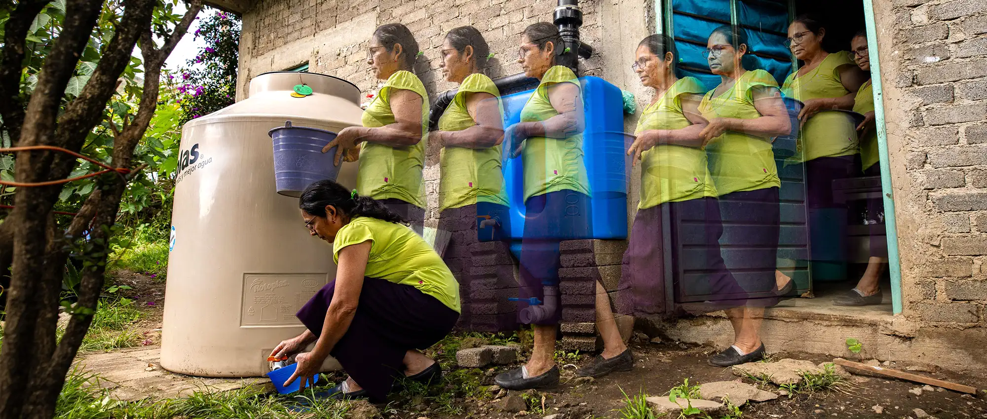 Agua-Vida-2025-Woman-Desk Agua Vida 2025. Woman walking to take some rain water from her rainwater harvesting system installed at her home in the Sierra Mazateca, Oaxaca, Mexico.