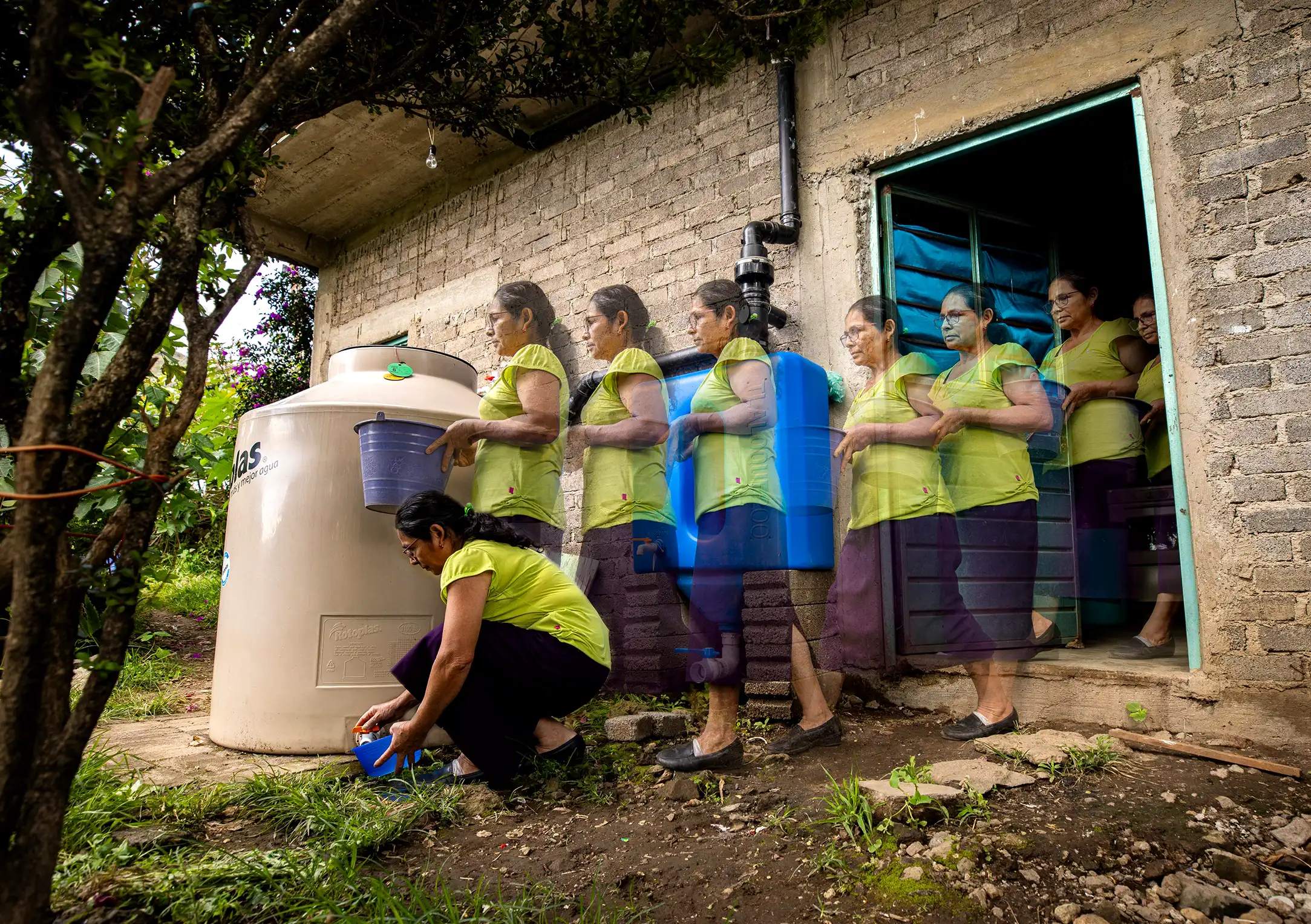Agua-Vida-2025-Woman Agua Vida 2025. Woman walking to take some rain water from her rainwater harvesting system installed at her home in the Sierra Mazateca, Oaxaca, Mexico.