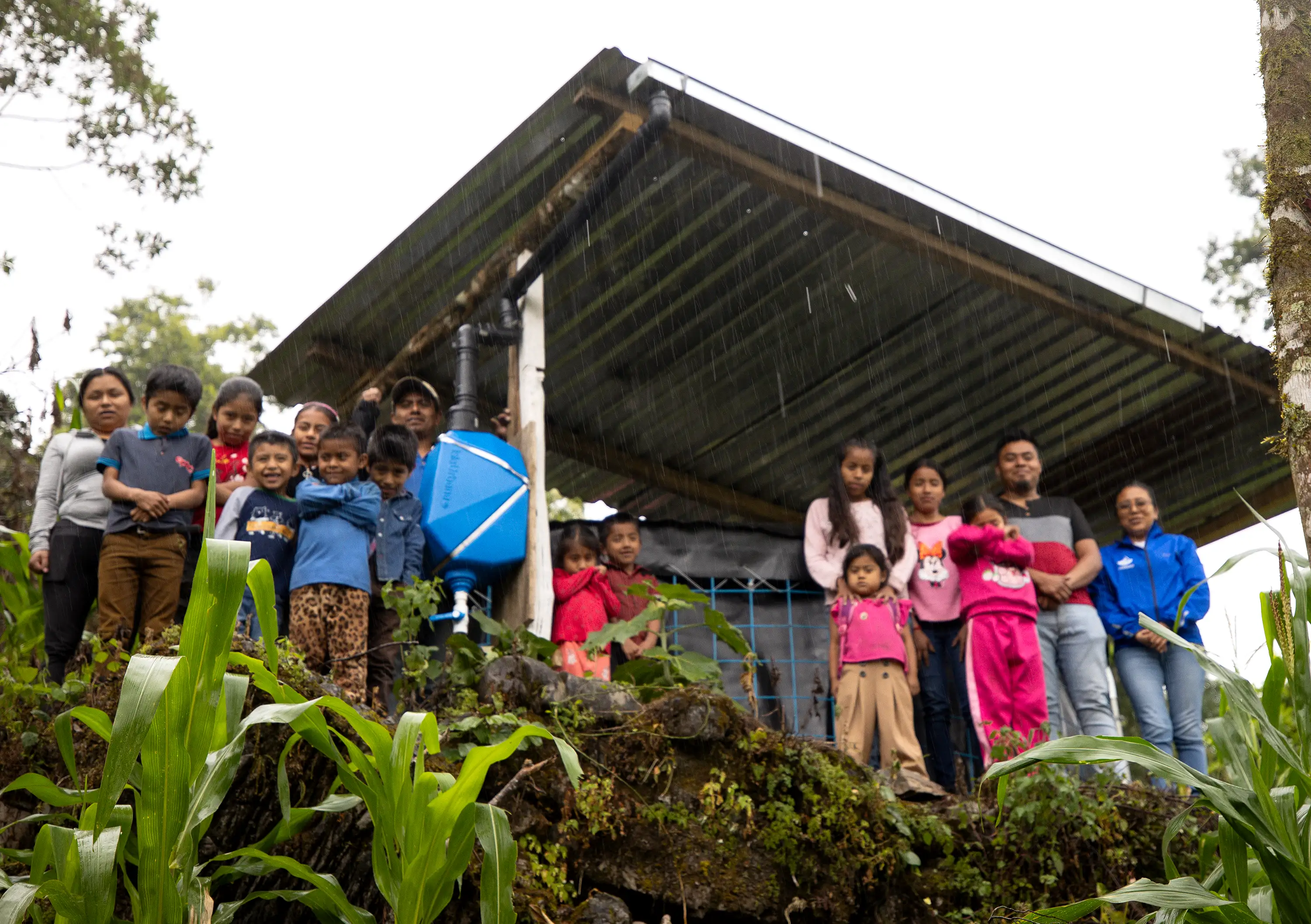 Agua Vida-Mazateca SCALL-mobile Agua Vida. A family reunited next to their rainwater harvesting system while is raining in the Sierra Mazateca in Oaxaca, Mexico.